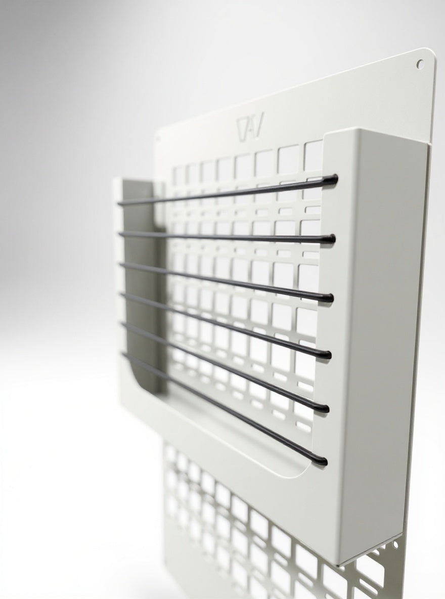 beige MOLLE shelf system with black bungee cords mounted on a flat panel.