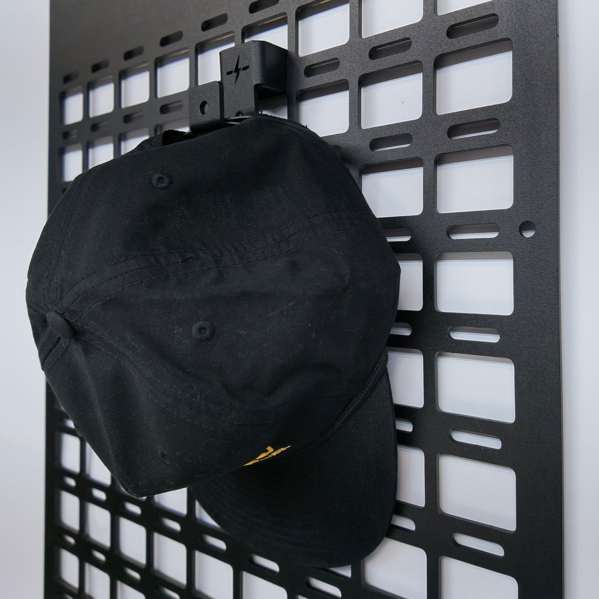 aluminum molle panel drop in hook hanging on molle panel system with hat hanging from panel