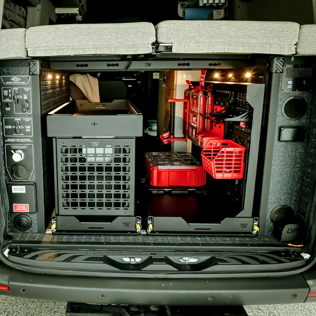 storyteller overland mode sprinter legless bed system 2.0 rails installed across garage with cargo tray slides below and bed folded down