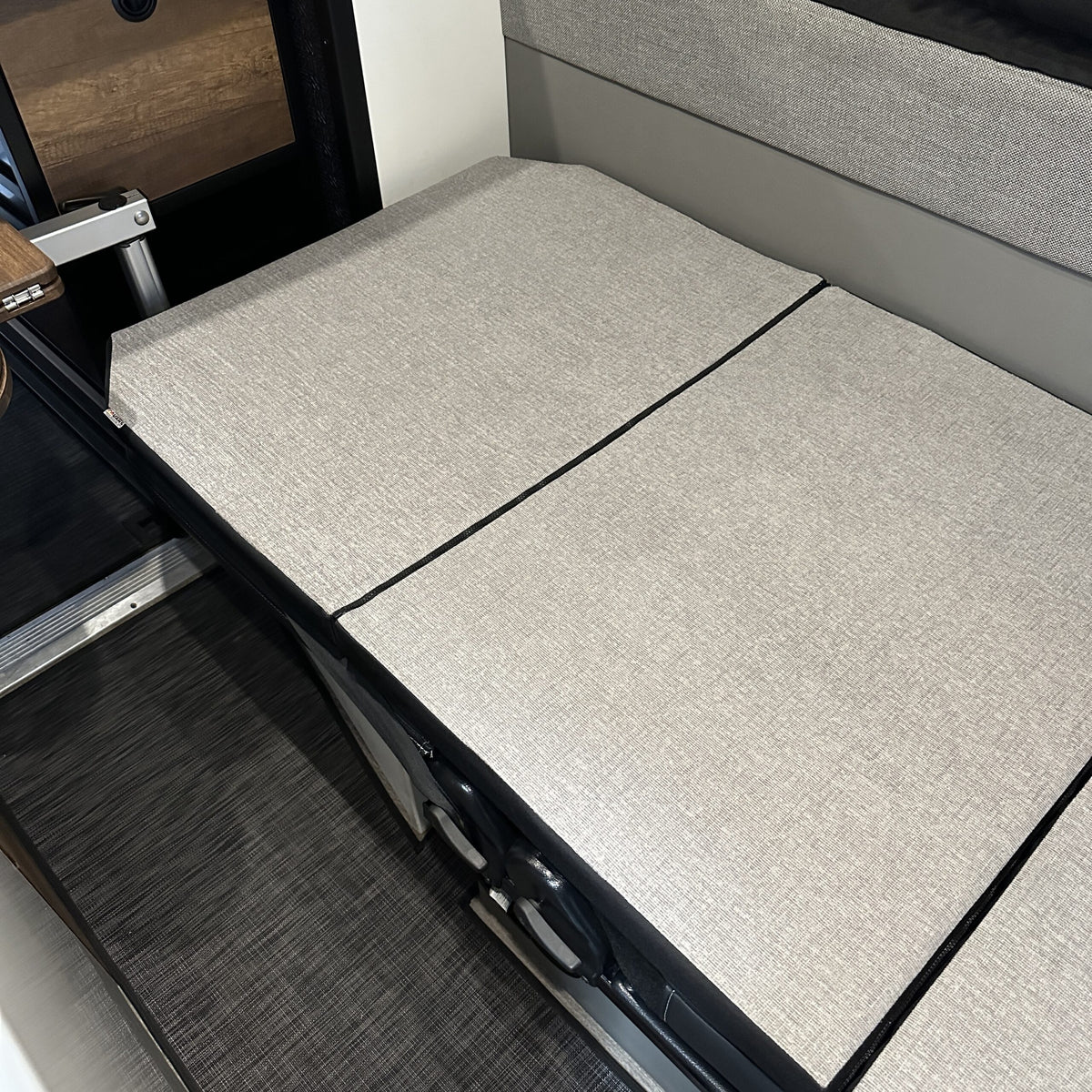 Groove Lounge Mattress Topper laid flat in Storyteller van interior setup for sleeping.