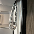 Revel bed harness cover installed on wall rail in van interior
