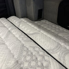 Close-up of ULTRA Luxe mattress in Storyteller Overland MODE van interior.