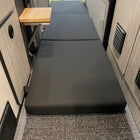 Revel floor mattress laid out in van interior with side table visible